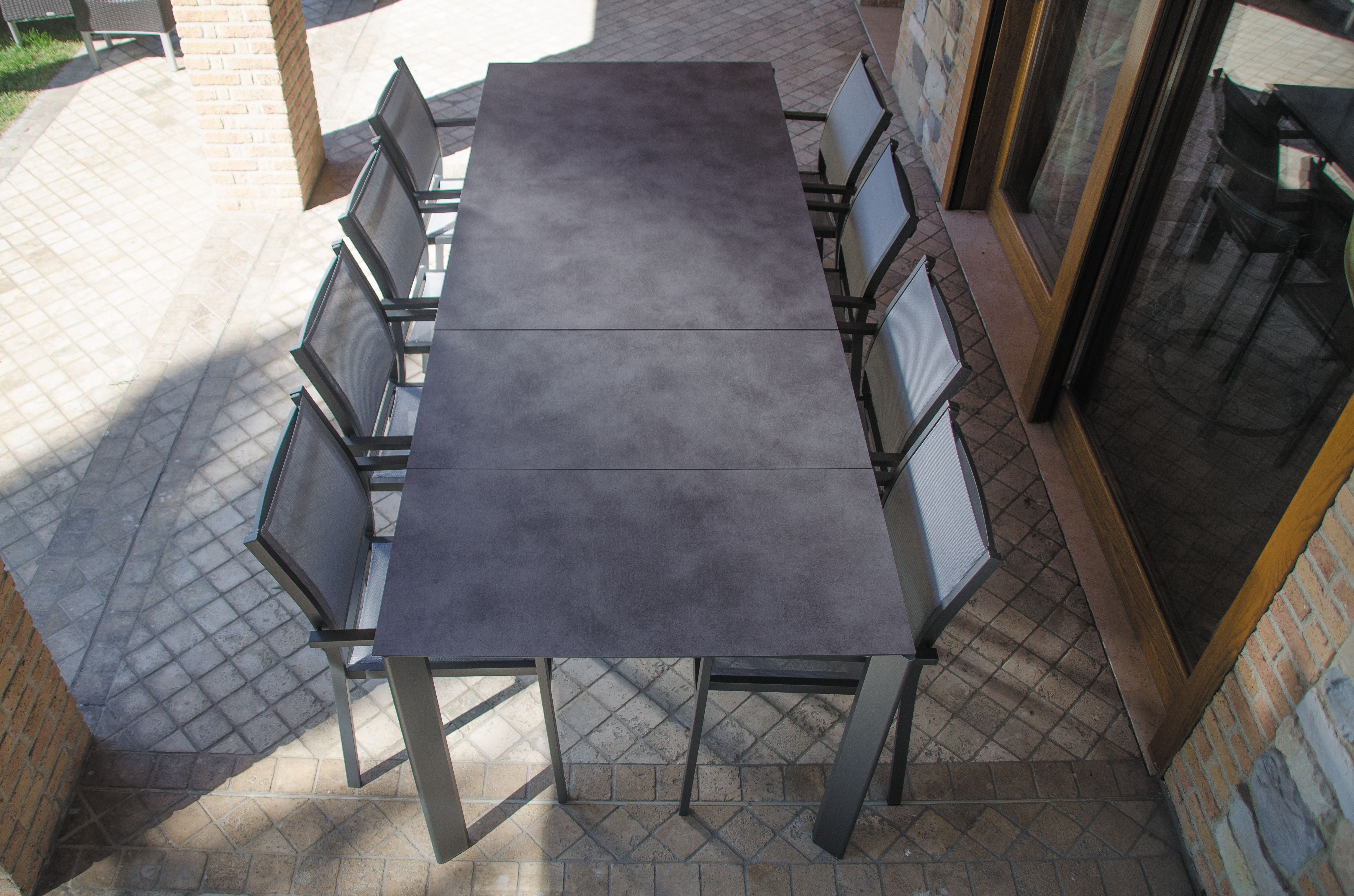 Alfa spisebord , utebord i antrasitt  med grå Aria stoler fra Fiam: Bord  med antrasitt aluminiumsben og cement HPL bordplate